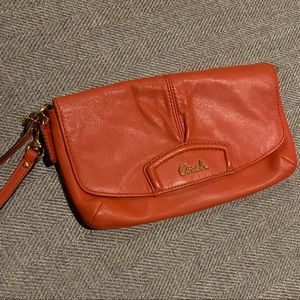 Orange leather Coach wristlet